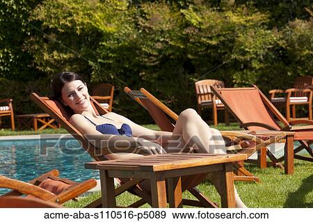 Italy, Amalfi Coast, Ravell, Young woman sunbathing at lounge chair View Large Photo Image Stock Photo - Italy, Amalfi Coast, Ravell, Young woman sunbathing at lounge chair. Fotosearch