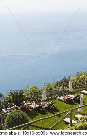 Italy, Amalfi Coast, Ravello, High angle view of lounge chairs with view on sea View Large Photo Image Stock Photography - Italy, Amalfi Coast, Ravello, High angle view of lounge chairs with view on sea . Fotosearch