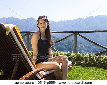 Italy, Amalfi Coast, Ravello, Portrait of mature woman sitting on lounge chair View Large Photo Image Picture - Italy, Amalfi Coast, Ravello, Portrait of mature woman sitting on lounge chair. Fotosearch
