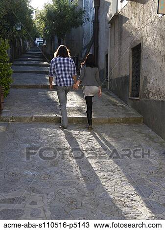 Italy, Amalfi Coast, Ravello, Young couple holding hands and walking, rear view View Large Photo Image Stock Image - Italy, Amalfi Coast, Ravello, Young couple holding hands and walking, rear view. Fotosearch