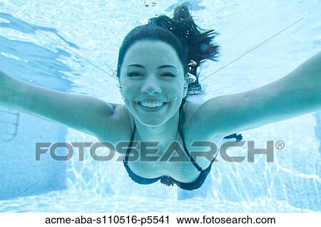 Italy, Amalfi Coast, Ravello, Young smiling woman swimming underwater, front view View Large Photo Image Stock Image - Italy, Amalfi Coast, Ravello, Young smiling woman swimming underwater, front view. Fotosearch