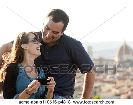 Italy, Florence, Couple viewing camera at lookout over old town View Large Photo Image Stock Photo - Italy, Florence, Couple viewing camera at lookout over old town. Fotosearch