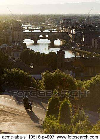 Italy, Florence, Couple with motorbike overlooking River Arno View Large Photo Image Stock Photo - Italy, Florence, Couple with motorbike overlooking River Arno. Fotosearch
