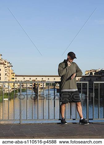 Italy, Florence, Man checking pulse on bridge over River Arno View Large Photo Image Stock Photo - Italy, Florence, Man checking pulse on bridge over River Arno . Fotosearch