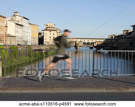 Italy, Florence, Man jogging past Ponte Vecchio over River Arno View Large Photo Image Stock Image - Italy, Florence, Man jogging past Ponte Vecchio over River Arno . Fotosearch