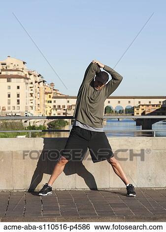 Italy, Florence, Man stretching by River Arno View Large Photo Image Stock Photograph - Italy, Florence, Man stretching by River Arno . Fotosearch