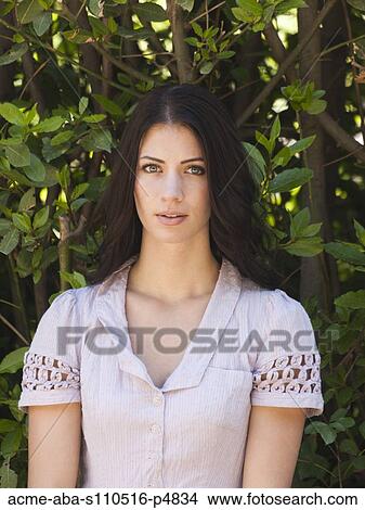 Italy, Florence, Portrait of young woman relaxing in park View Large Photo Image Picture - Italy, Florence, Portrait of young woman relaxing in park. Fotosearch