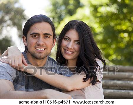 Italy, Florence, Portrait of young couple embracing outdoors View Large Photo Image Stock Image - Italy, Florence, Portrait of young couple embracing outdoors. Fotosearch