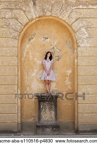 Italy, Florence, Portrait of young woman standing under arch View Large Photo Image Stock Image - Italy, Florence, Portrait of young woman standing under arch. Fotosearch