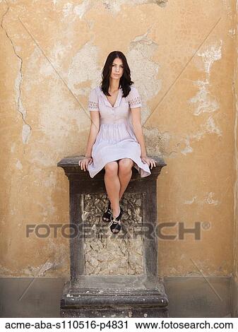 Italy, Florence, Portrait of young woman relaxing by wall View Large Photo Image Stock Image - Italy, Florence, Portrait of young woman relaxing by wall. Fotosearch