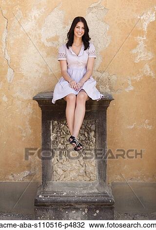 Italy, Florence, Portrait of young woman relaxing by wall View Large Photo Image Stock Image - Italy, Florence, Portrait of young woman relaxing by wall. Fotosearch