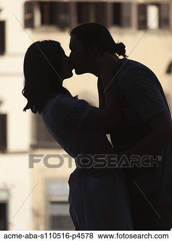 Stock Photo - Italy, Florence, Romantic couple kissing in city. Fotosearch