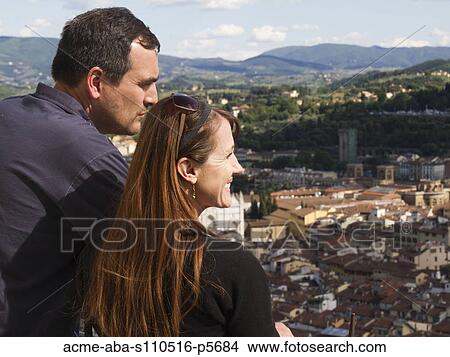 Italy, Florence, Smiling couple looking at townscape View Large Photo Image Picture - Italy, Florence, Smiling couple looking at townscape. Fotosearch