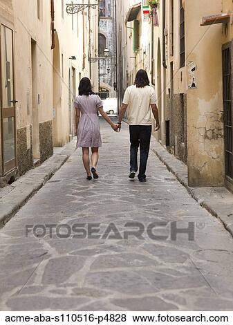 Stock Photo - Italy, Florence, Young couple walking in old town. Fotosearch