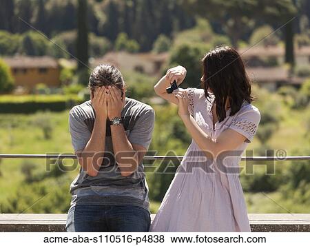 Italy, Florence, Young woman photographing young man in rural area View Large Photo Image Stock Photo - Italy, Florence, Young woman photographing young man in rural area. Fotosearch