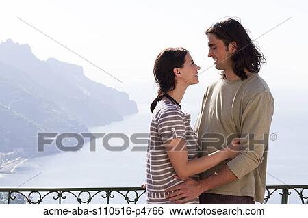 Stock Photograph - Italy, Ravello, Couple embracing on terrace. Fotosearch