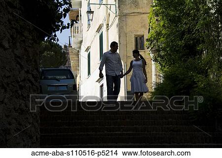 Picture - Italy, Ravello, Couple walking on street of old town. Fotosearch