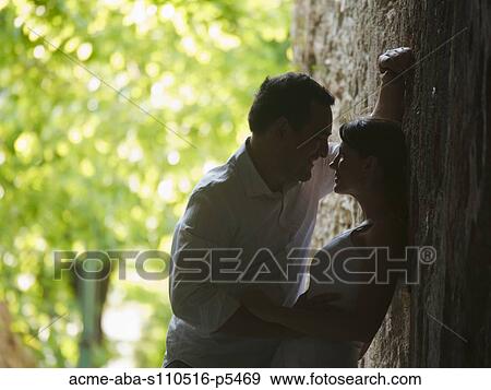 Stock Photo - Italy, Ravello, Mature couple kissing in narrow lane. Fotosearch