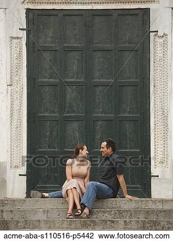Stock Image - Italy, Ravello, Mature couple sitting on stairs. Fotosearch