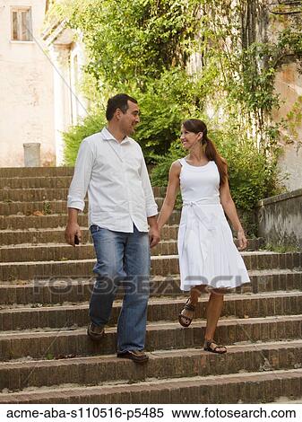 Stock Photography - Italy, Ravello, Mature couple walking down stairs. Fotosearch
