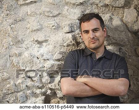 Italy, Ravello, Mature man leaning against stone wall View Large Photo Image Stock Photo - Italy, Ravello, Mature man leaning against stone wall. Fotosearch
