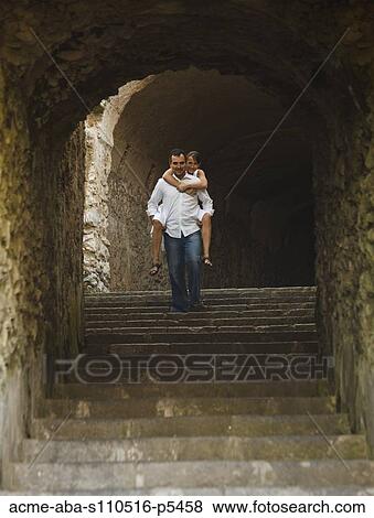 Italy, Ravello, Mature woman piggyback riding on man in stone archway View Large Photo Image Stock Photo - Italy, Ravello, Mature woman piggyback riding on man in stone archway. Fotosearch