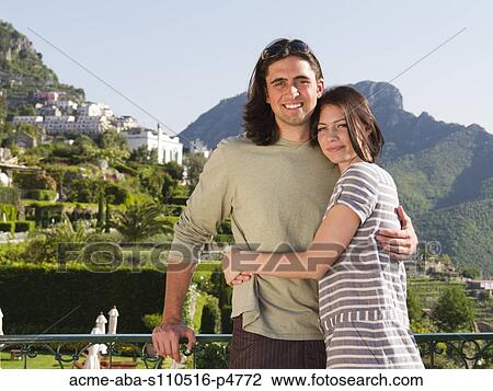 Italy, Ravello, Portrait of young couple smiling near mountain town View Large Photo Image Stock Image - Italy, Ravello, Portrait of young couple smiling near mountain town. Fotosearch