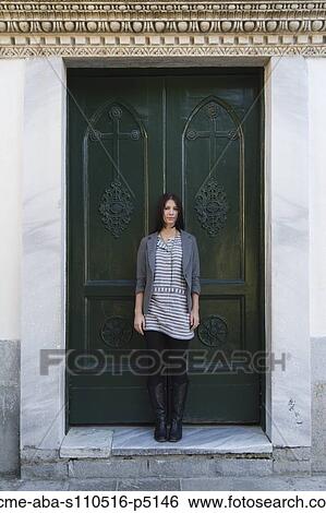 Italy, Ravello, Portrait of young woman standing in front of door View Large Photo Image Stock Photograph - Italy, Ravello, Portrait of young woman standing in front of door. Fotosearch