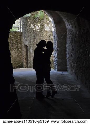 Stock Photo - Italy, Ravello, Silhouettes of couple kissing in gate. Fotosearch