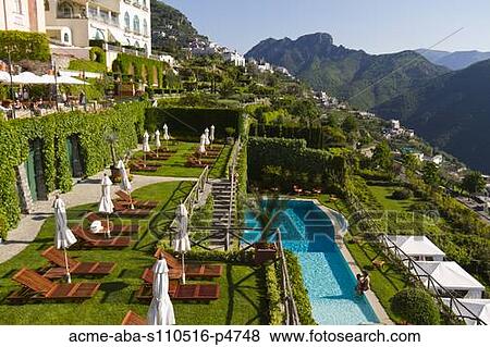 Stock Photo - Italy, Ravello, Terrace with outdoor pool and couple kissing. Fotosearch