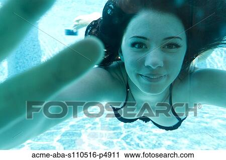 Stock Image - Italy, Ravello, Underwater portrait of swimming woman. Fotosearch