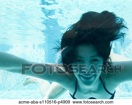 Stock Photo - Italy, Ravello, Underwater portrait of swimming woman. Fotosearch