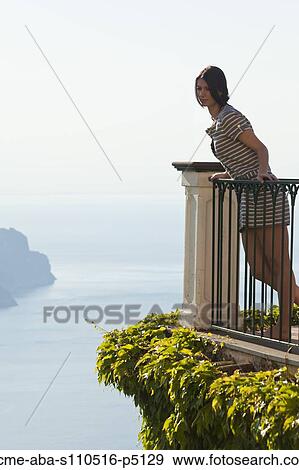 Italy, Ravello, Woman leaning at balustrade and looking at view View Large Photo Image Stock Photo - Italy, Ravello, Woman leaning at balustrade and looking at view. Fotosearch