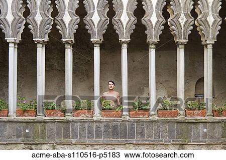 Italy, Ravello, Woman standing on balcony between ornate columns View Large Photo Image Stock Image - Italy, Ravello, Woman standing on balcony between ornate columns. Fotosearch