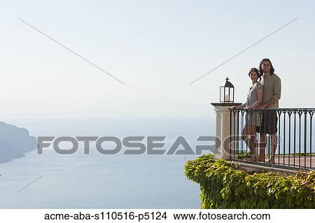 Italy, Ravello, Young couple standing together at balustrade View Large Photo Image Picture - Italy, Ravello, Young couple standing together at balustrade. Fotosearch