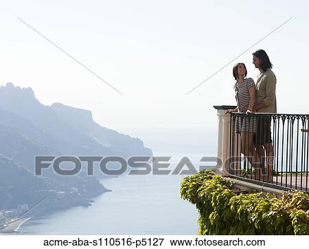 Italy, Ravello, Young couple standing together at balustrade View Large Photo Image Stock Photo - Italy, Ravello, Young couple standing together at balustrade. Fotosearch