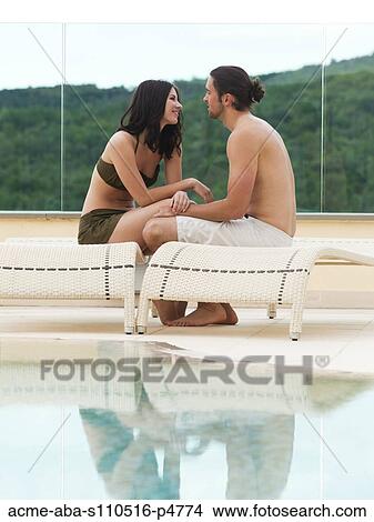 Italy, Romantic couple relaxing by swimming pool View Large Photo Image Picture - Italy, Romantic couple relaxing by swimming pool. Fotosearch