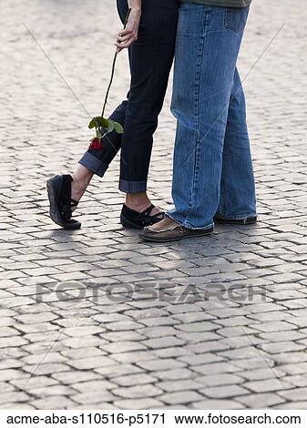 Italy, Rome, Vatican City, Close up of legs of couple with rose standing on cobblestone View Large Photo Image Stock Image - Italy, Rome, Vatican City, Close up of legs of couple with rose standing on cobblestone . Fotosearch