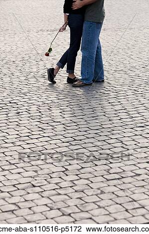 Italy, Rome, Vatican City, Close up of legs of couple with rose standing on cobblestone View Large Photo Image Stock Image - Italy, Rome, Vatican City, Close up of legs of couple with rose standing on cobblestone . Fotosearch