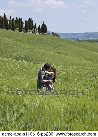 Italy, Tuscany, Couple kissing on meadow View Large Photo Image Stock Photograph - Italy, Tuscany, Couple kissing on meadow. Fotosearch