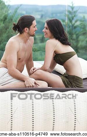 Italy, Tuscany, Couple sitting on outdoor bed View Large Photo Image Stock Photo - Italy, Tuscany, Couple sitting on outdoor bed. Fotosearch