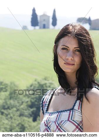 Italy, Tuscany, Portrait of young woman on field View Large Photo Image Stock Photo - Italy, Tuscany, Portrait of young woman on field. Fotosearch