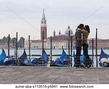 Stock Image - Italy, Tuscany, Young couple embracing in old house. Fotosearch