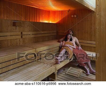 Stock Photograph - Italy, Tuscany, Young couple relaxing in sauna. Fotosearch