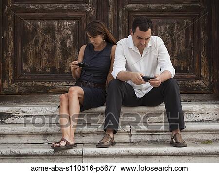 Stock Photo - Italy, Venice, Couple sitting on steps. Fotosearch