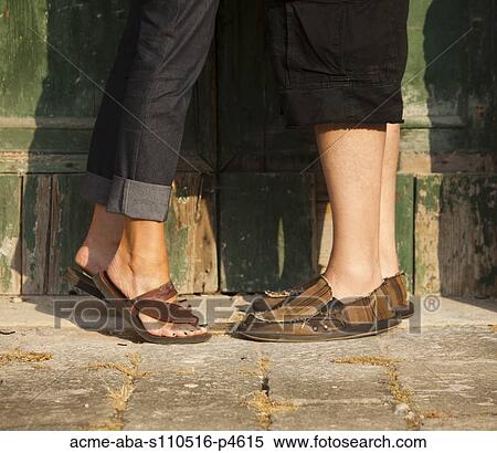 Stock Photography - Italy, Venice, Couple standing by wooden door in old town. Fotosearch