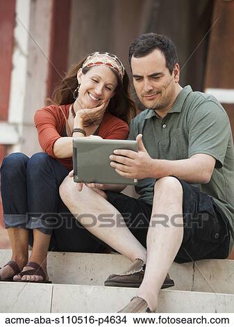 Italy, Venice, Couple using laptop on steps View Large Photo Image Picture - Italy, Venice, Couple using laptop on steps. Fotosearch