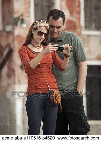 Italy, Venice, Couple viewing digital camera in city View Large Photo Image Stock Image - Italy, Venice, Couple viewing digital camera in city. Fotosearch