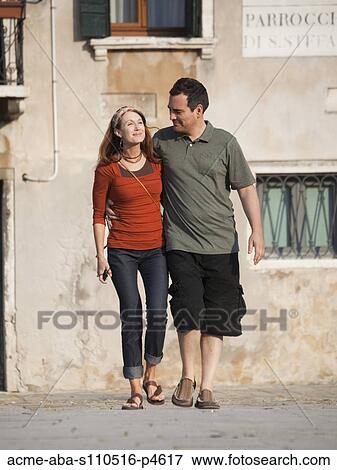 Italy, Venice, Couple walking in old town View Large Photo Image Stock Photo - Italy, Venice, Couple walking in old town. Fotosearch