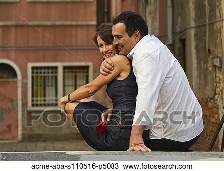 Italy, Venice, Happy mature couple embracing, woman holding single red rose View Large Photo Image Stock Image - Italy, Venice, Happy mature couple embracing, woman holding single red rose. Fotosearch